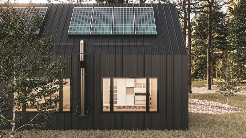 Small modern black cabin with solar panels on the roof