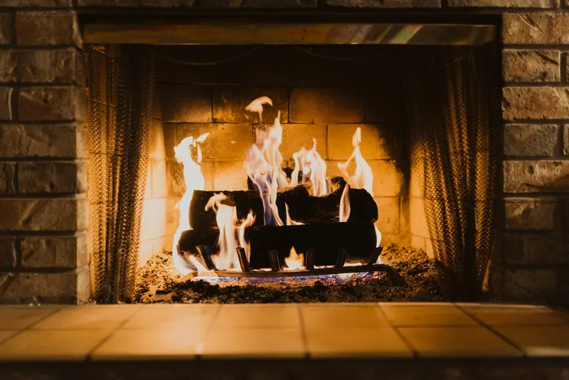 Wood fire burning in a brick fireplace