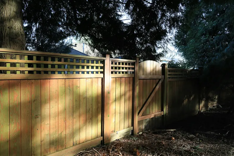Wood privacy fence with lattice top and a gate