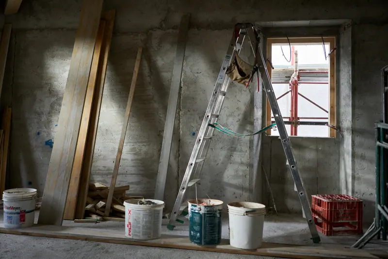 Room under construction with a ladder and paint buckets