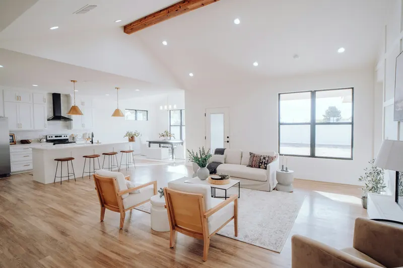 Renovated open living room and kitchen with wood flooring