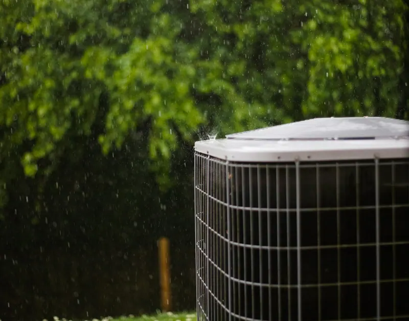 Outdoor air conditioning condenser in a garden