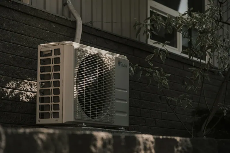 Ductless mini-split outdoor unit mounted on a wall