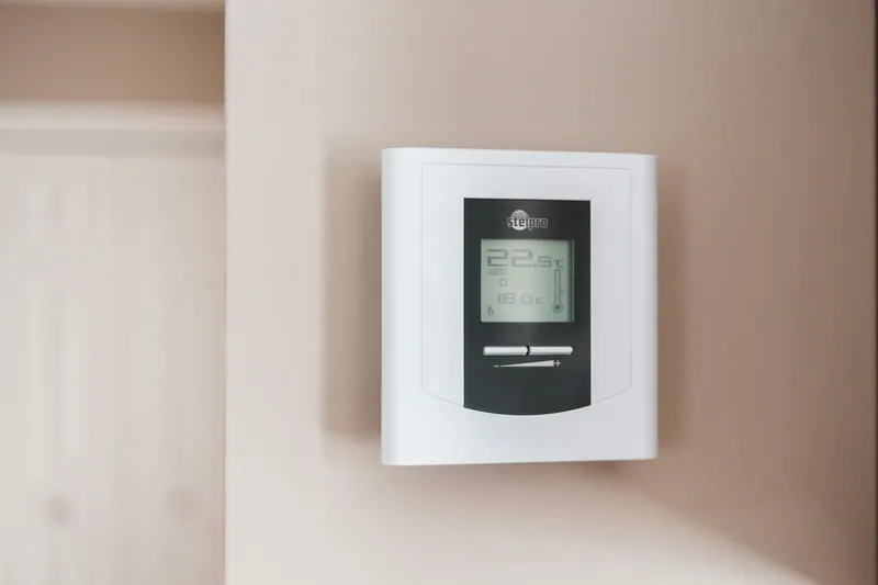 Digital thermostat on a wall