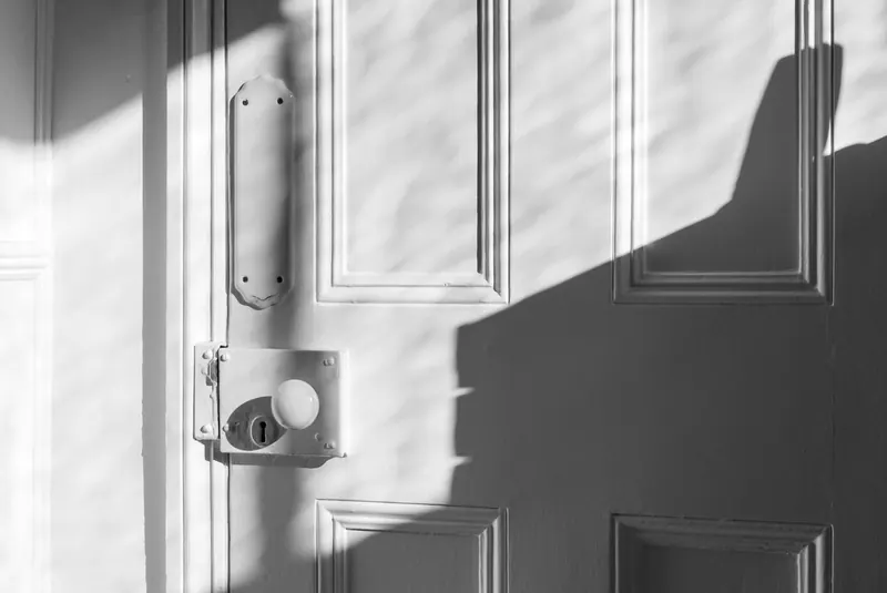 Lock and latch on a white paneled door