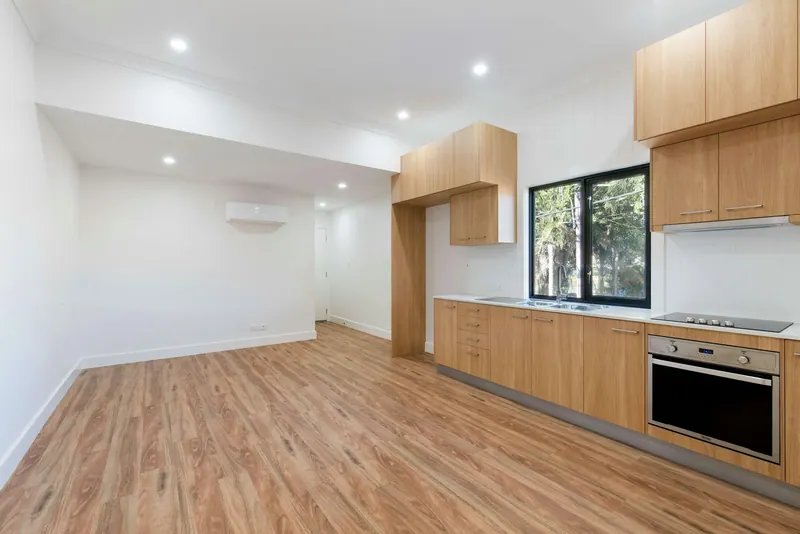 New kitchen with wood cabinets and plank flooring