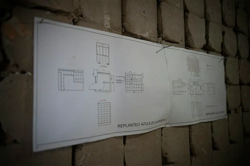 Floor plan sheet pinned to a wall
