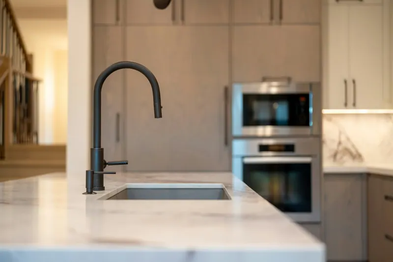 Black faucet on a kitchen island sink