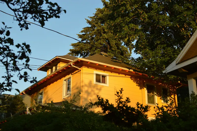 Yellow craftsman house in evening light